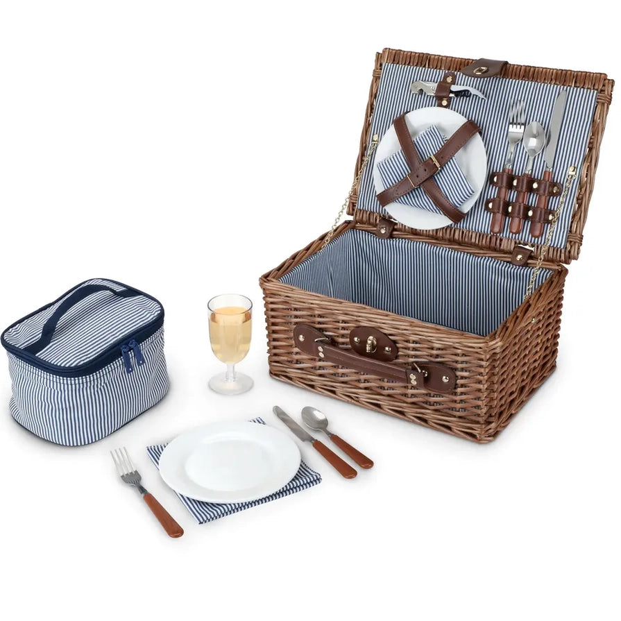 picnic basket open, with plates, utensils, cup, and bottle opener