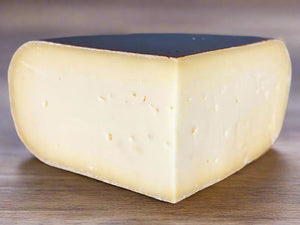 quarter wheel of cheese, with small holes