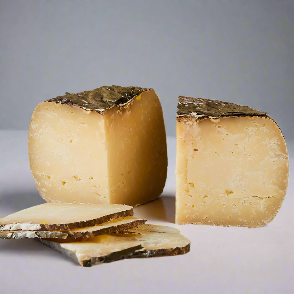 yellow paste cheese wheel, in two quarters, with thin slices. walnut leaves ontop