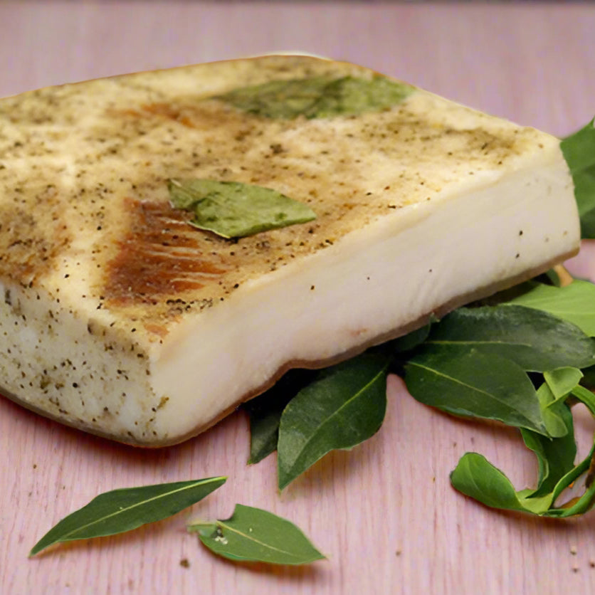 mangalista lardo, block of white looking meat, with bay leaves