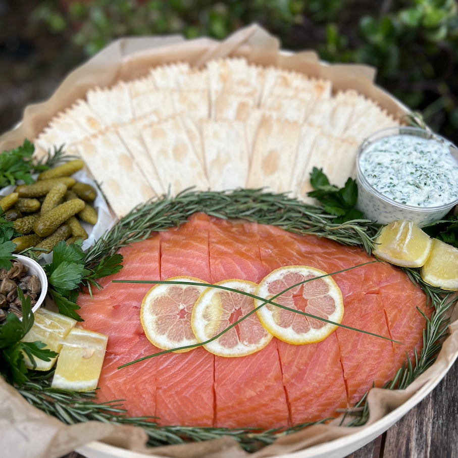 Platter with smoked salmon, crackers, creme fraiche, capers, and pickles