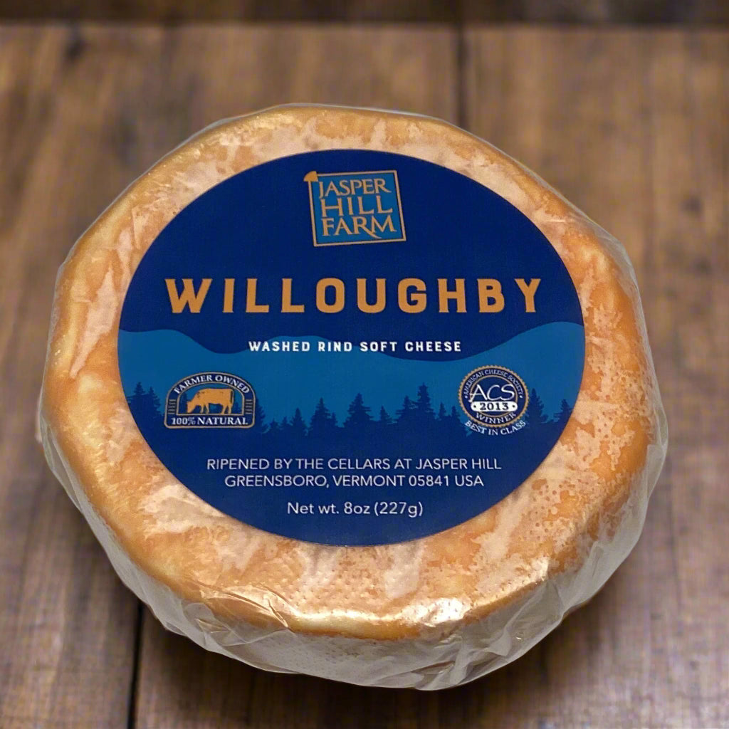 close-up shot of willoughby in retail plastic wrapper with label, round disk.