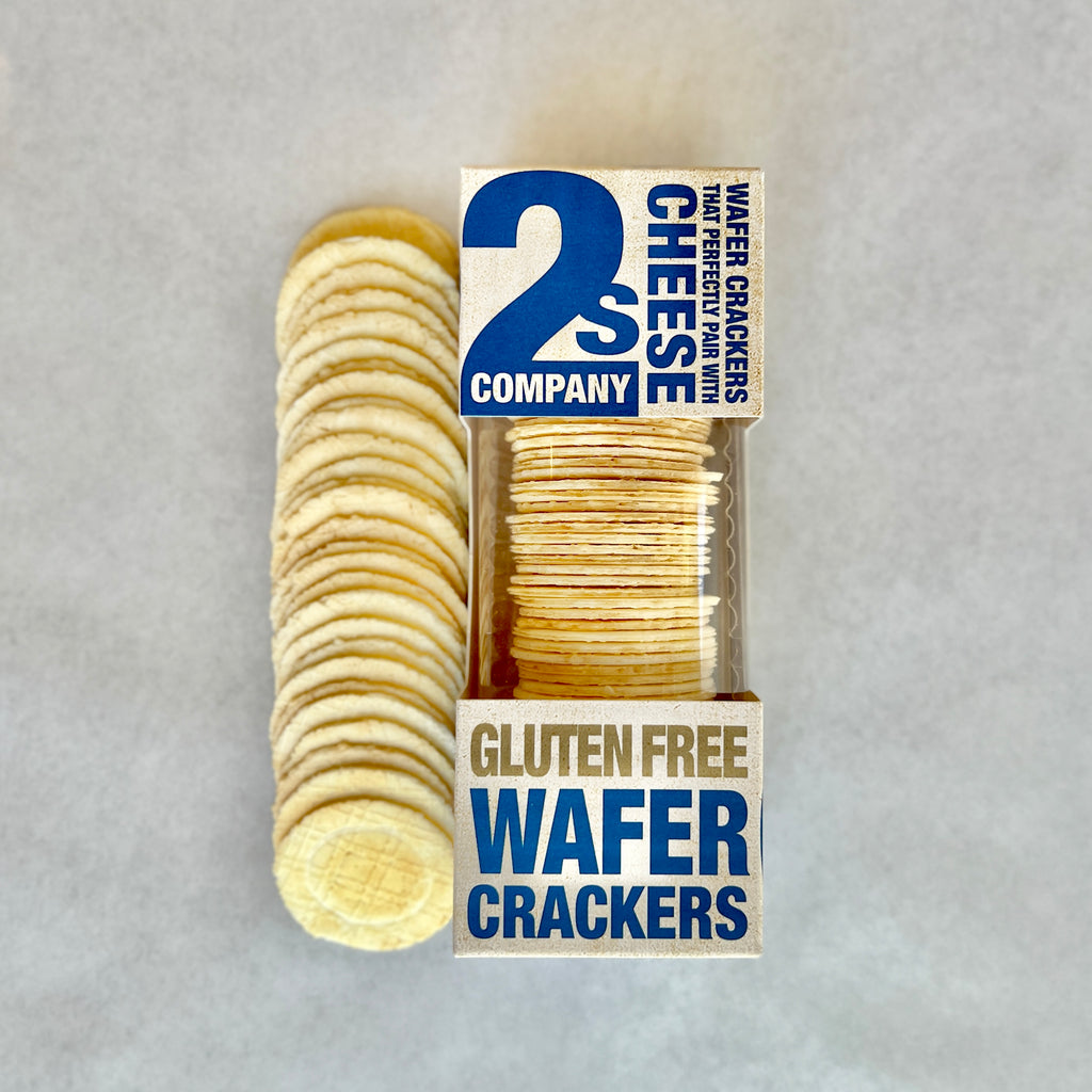 row of gluten free wafer crackers, circular, next to retail packaging